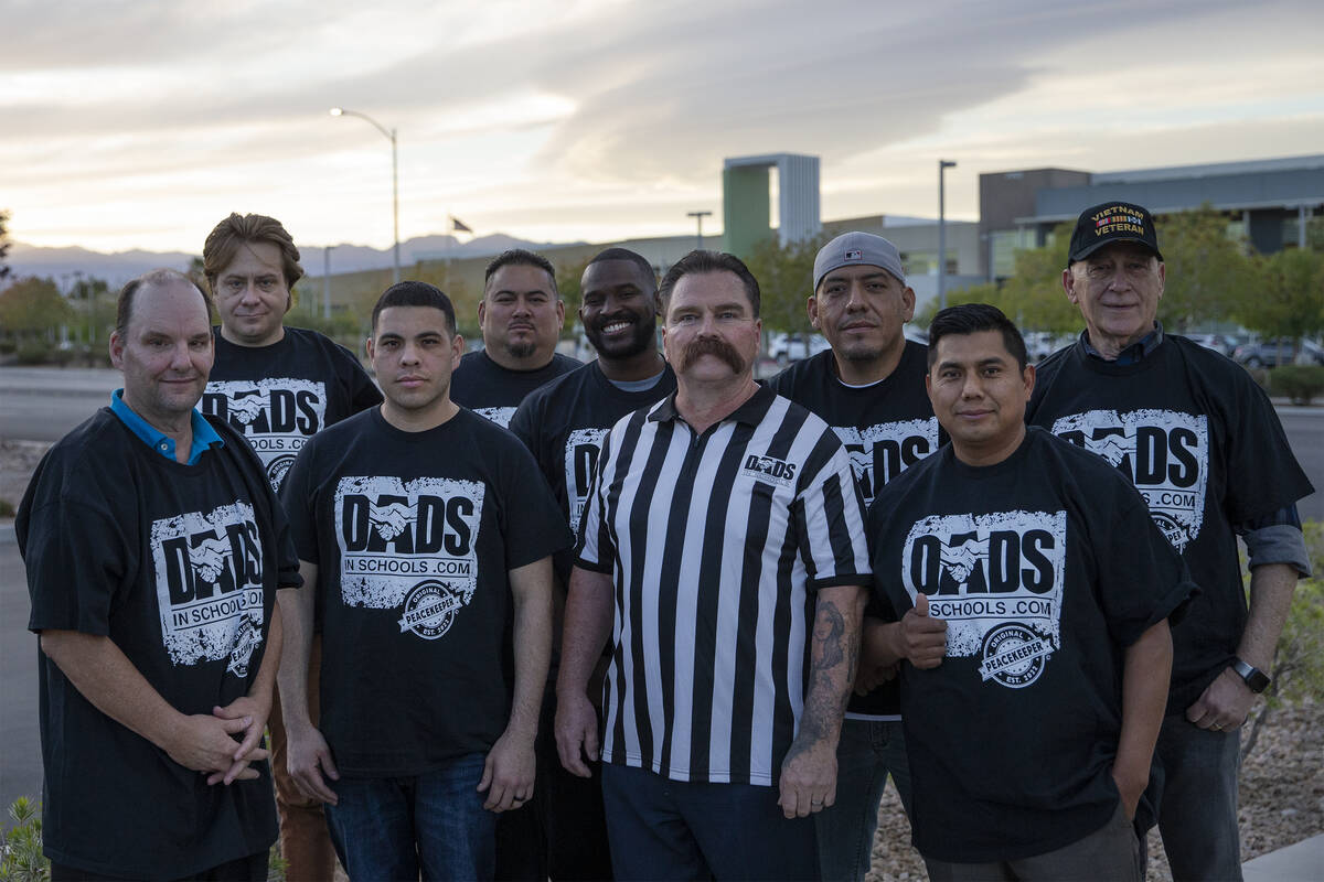 Pastor Troy Martinez, fourth from right, poses for a portrait with a group of CCSD fathers afte ...