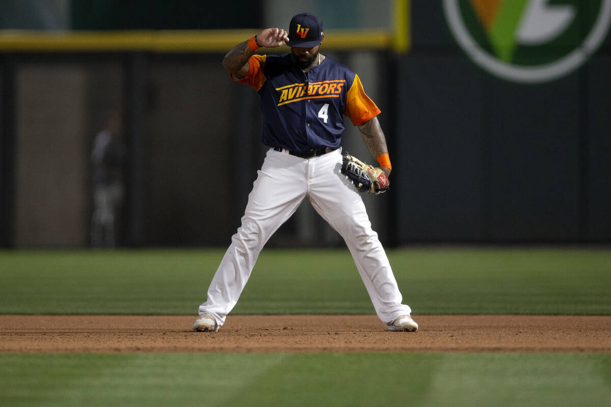 Las Vegas Aviators first baseman Eric Thames (4) adjusts his hat in between play during a Minor ...