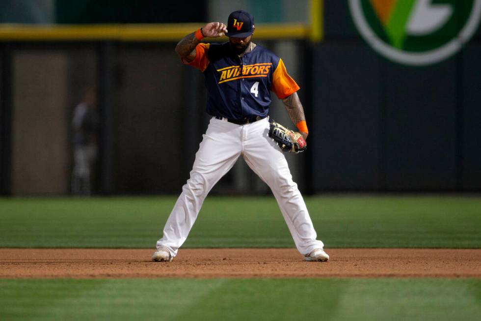 Las Vegas Aviators first baseman Eric Thames (4) adjusts his hat in between play during a Minor ...