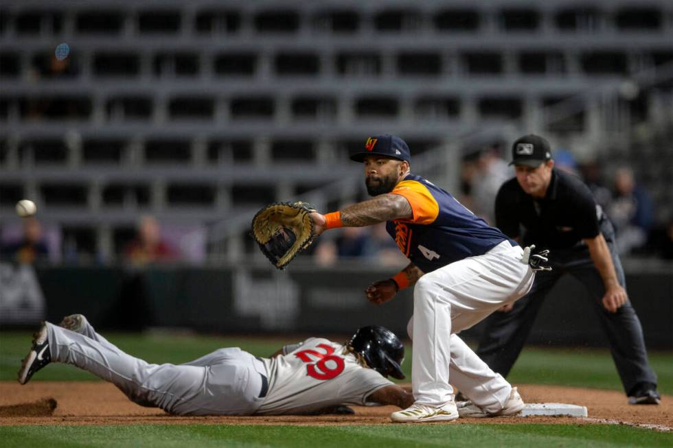 Las Vegas Aviators first baseman Eric Thames (4) attempts an out against El Paso Chihuahuas inf ...
