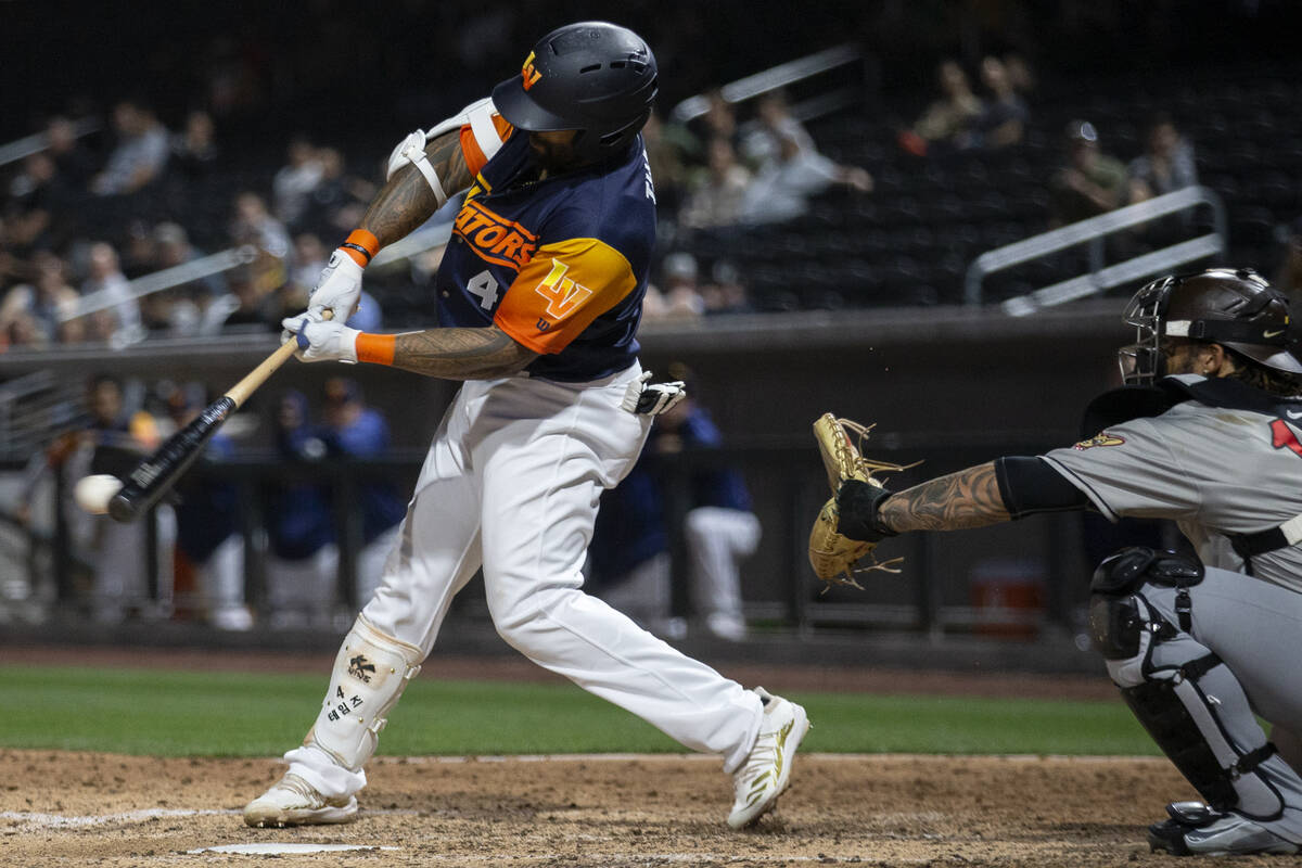Las Vegas Aviators slugger Eric Thames (4) hits a single with the bases loaded during the seven ...