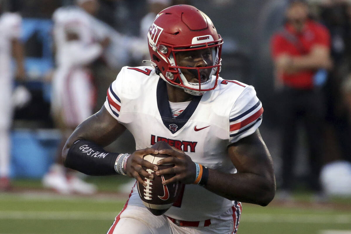 Liberty quarterback Malik Willis (7) carries the ball against Troy during the first half of an ...