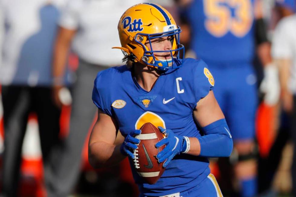 Pittsburgh quarterback Kenny Pickett drops back to pass during the first half of an NCAA colleg ...