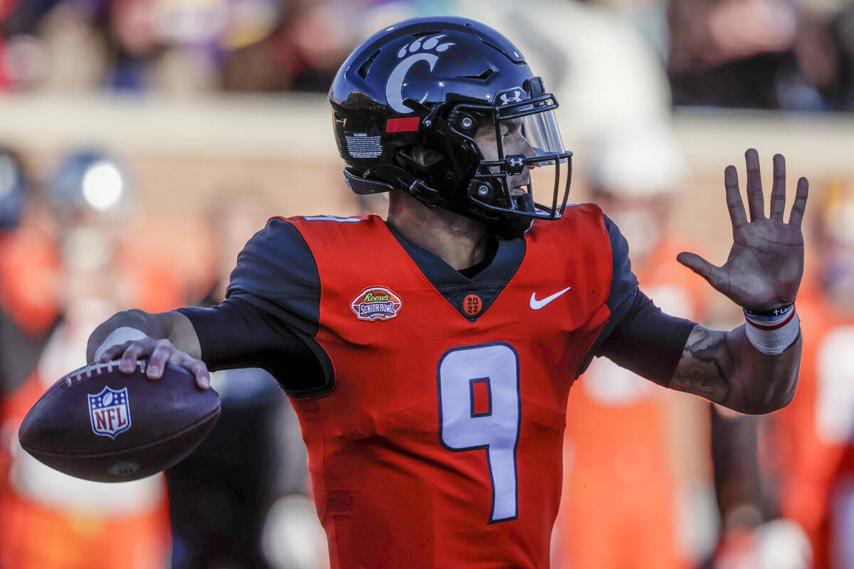 National Team quarterback Desmond Ridder of Cincinnati (9) throws a pass in an NCAA college foo ...