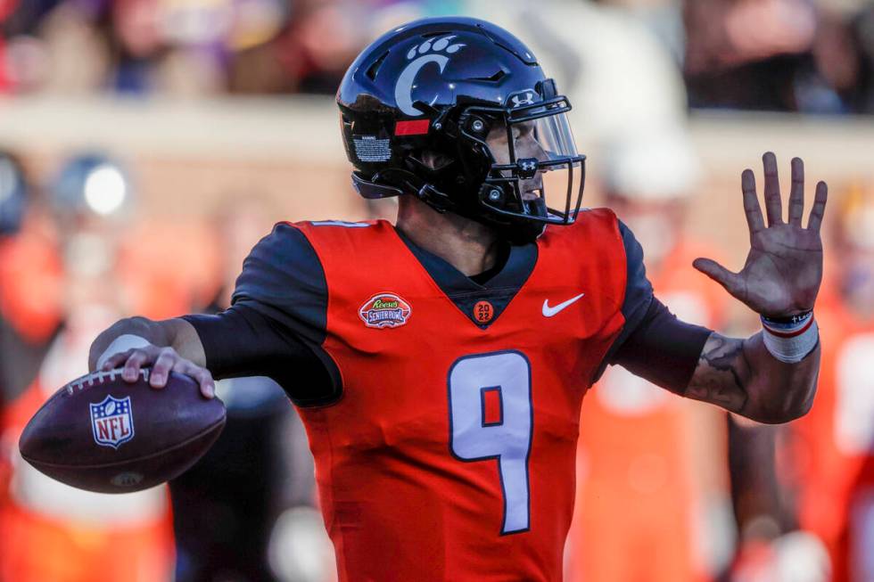 National Team quarterback Desmond Ridder of Cincinnati (9) throws a pass in an NCAA college foo ...