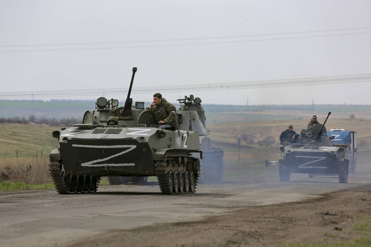 Russian military vehicles move on a highway in an area controlled by Russian-backed separatist ...