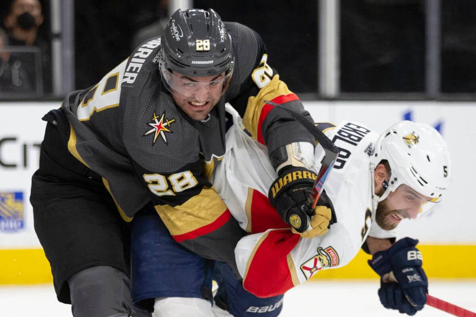 Golden Knights left wing William Carrier (28) collides with Panthers defenseman Aaron Ekblad (5 ...