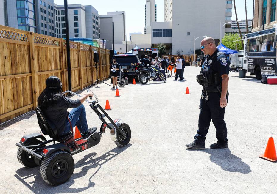 Clark County School District police officer Aaron Case helps Maria Silva attempt a driving into ...