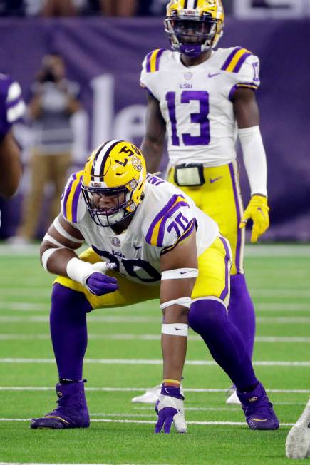 LSU guard Ed Ingram (70) in front of quarterback Jontre Kirklin (13) during the second half of ...