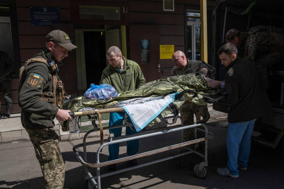 Ukrainian military medics transport an injured Ukrainian serviceman in Donetsk region, eastern ...