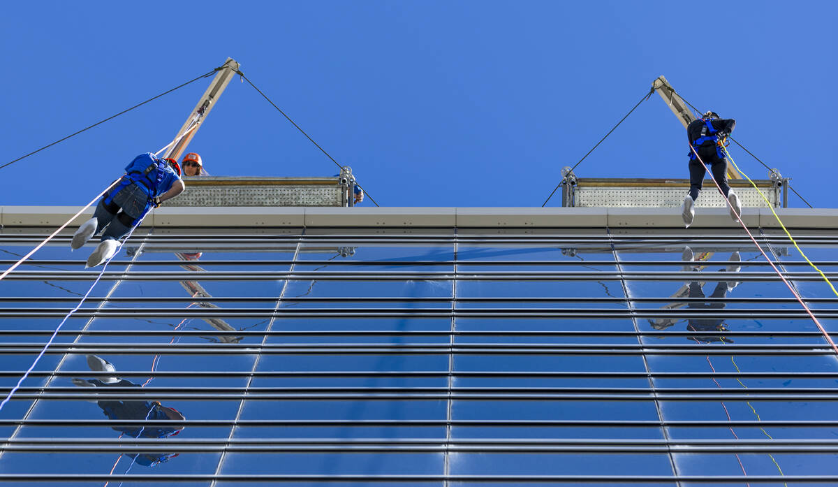 Rappellers Michelle Jackson, left, and Tina Quigley begin to work their way from the roof at th ...