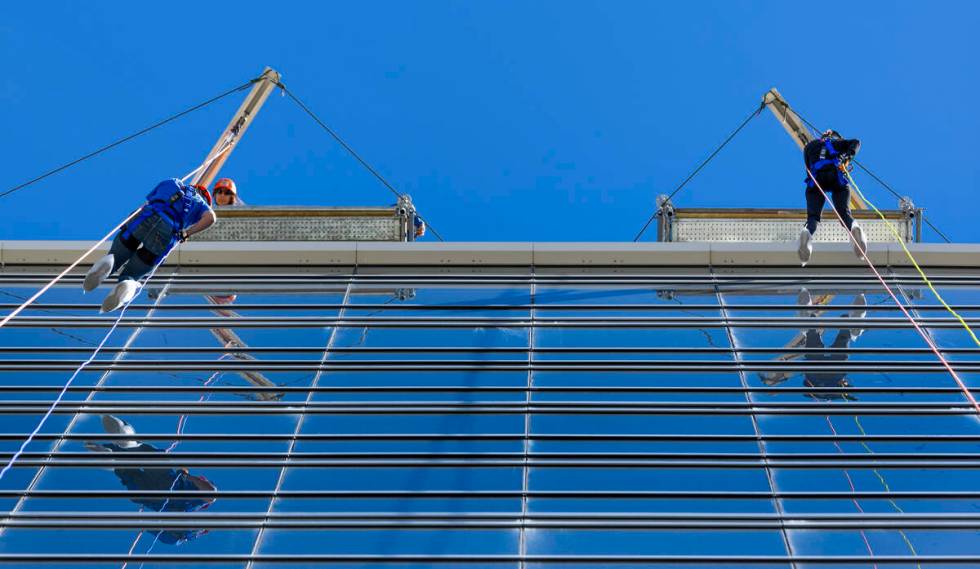 Rappellers Michelle Jackson, left, and Tina Quigley begin to work their way from the roof at th ...