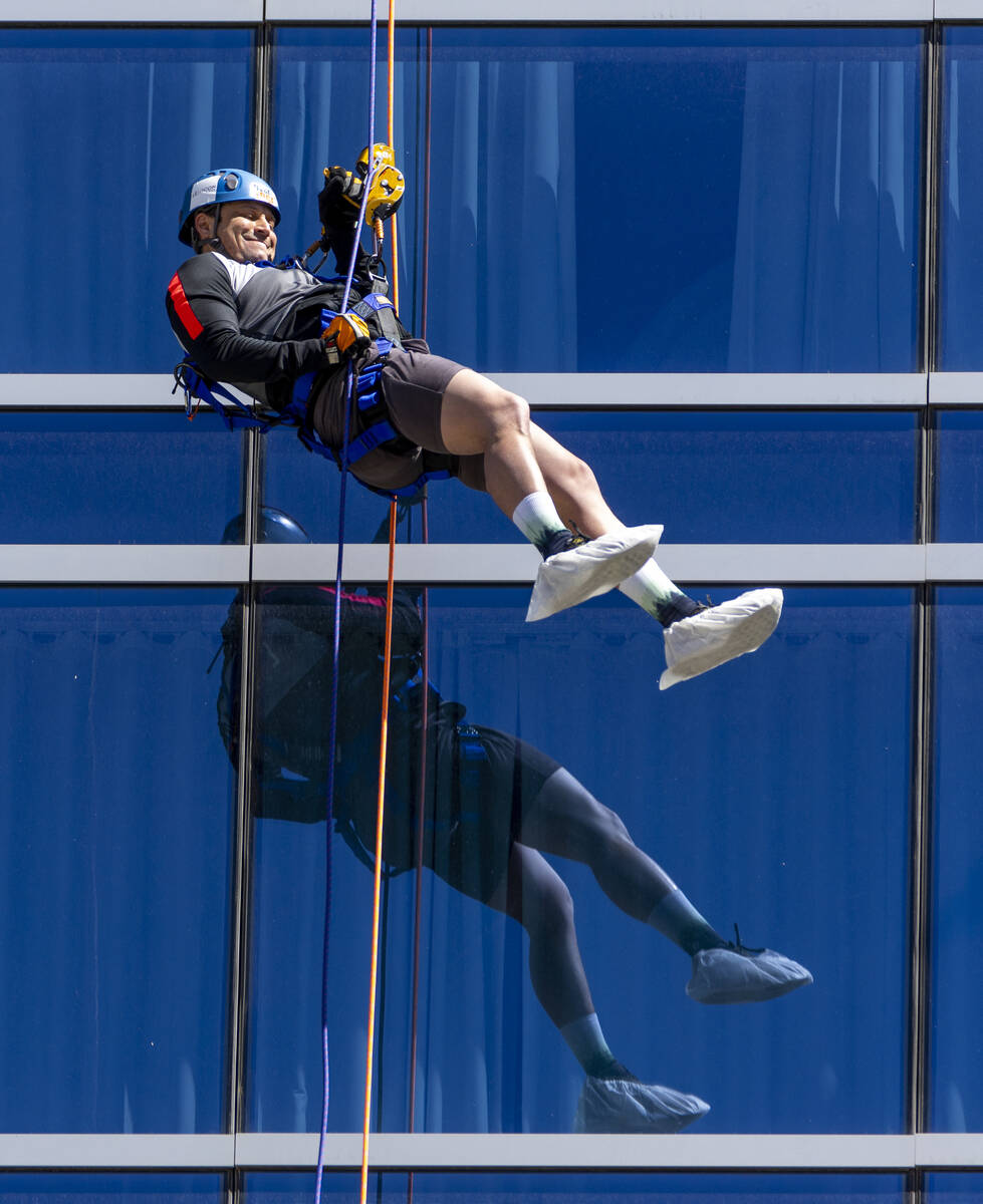 Rappeller Josh Crame with WestPac Wealth Partners eases down from the roof at the Opal Tower at ...