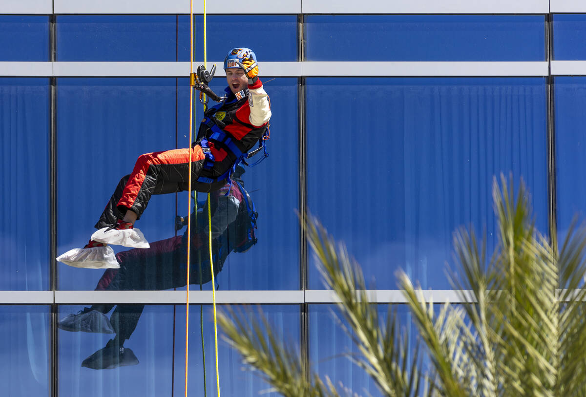 Rappeller Taylor Barton with the Las Vegas Mini Grand Prix celebrates as he slides down from th ...