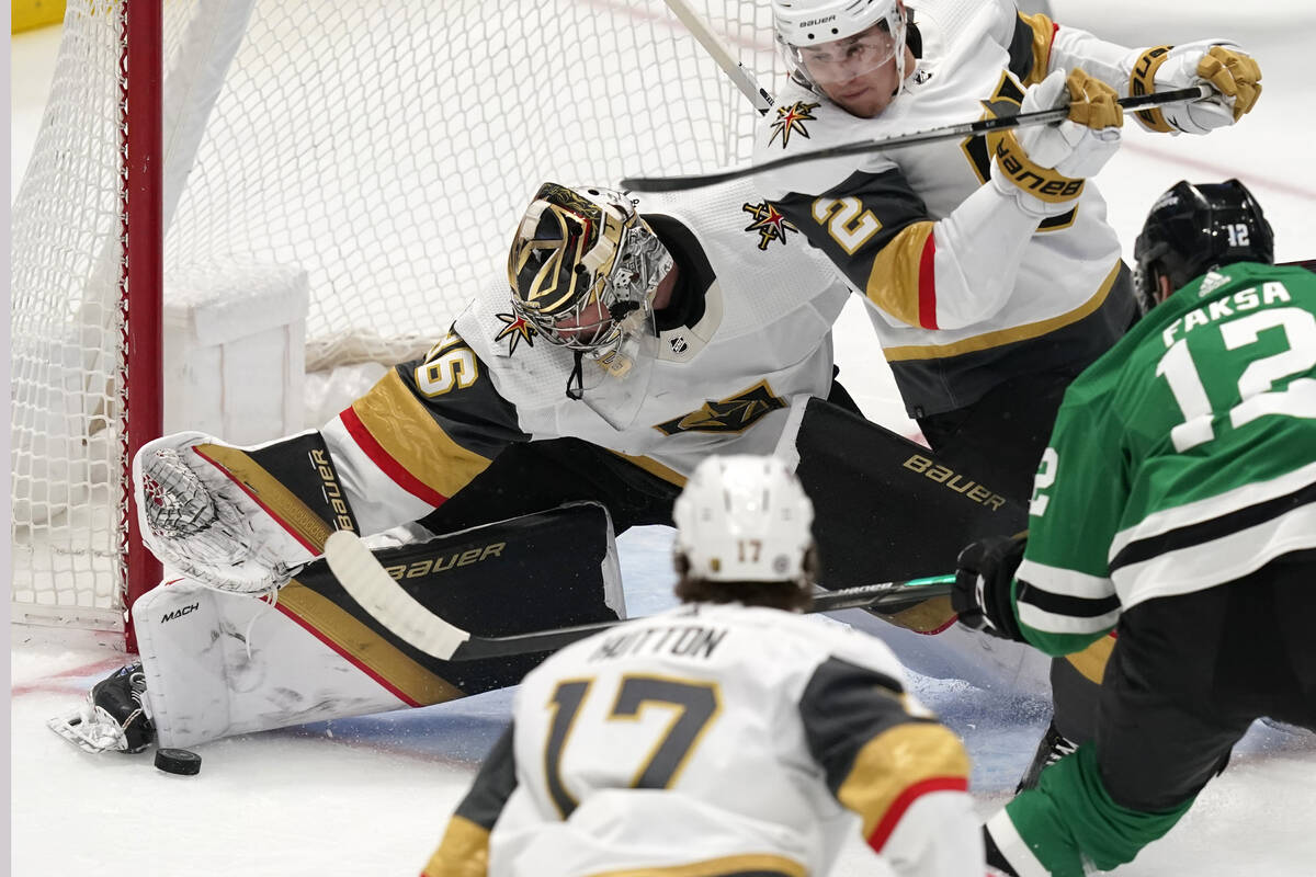 Vegas Golden Knights goaltender Logan Thompson (36) defends the goal with help from Zach Whitec ...