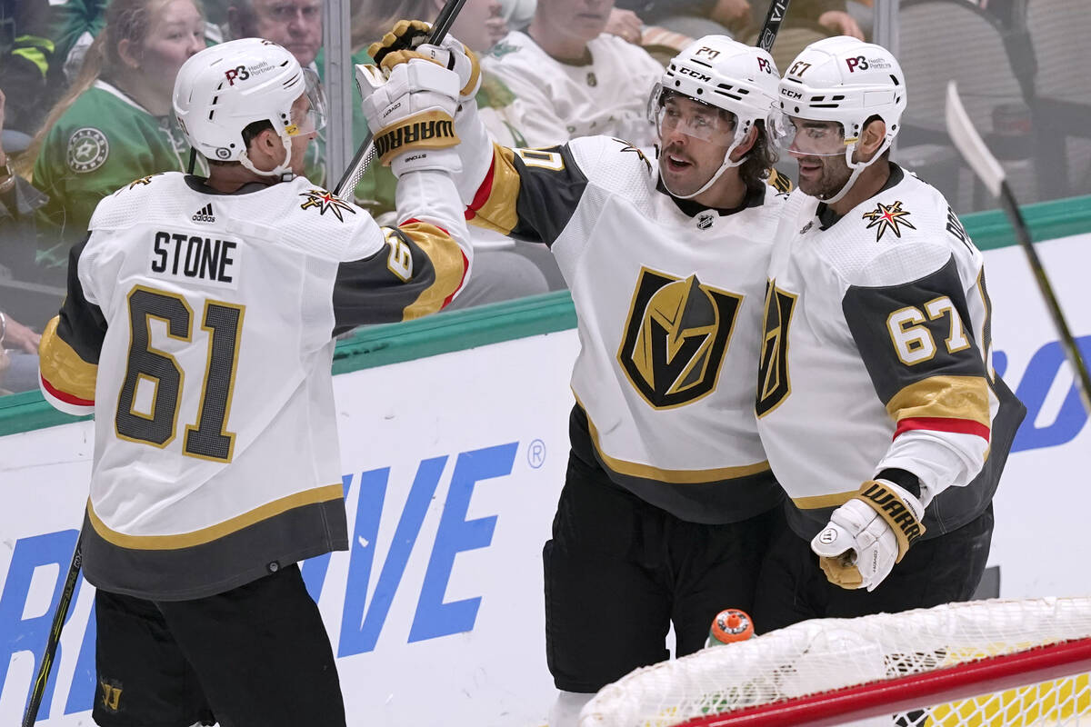 Vegas Golden Knights center Chandler Stephenson (20) celebrates his goal with Mark Stone (61) a ...