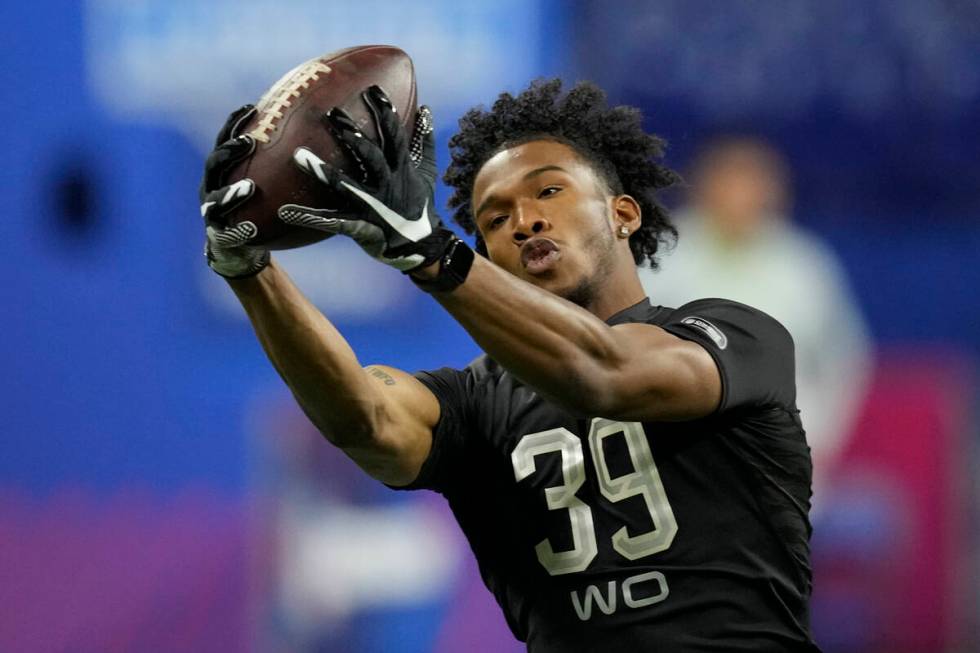 Ohio State wide receiver Garrett Wilson catches a pass during a drill at the NFL football scout ...