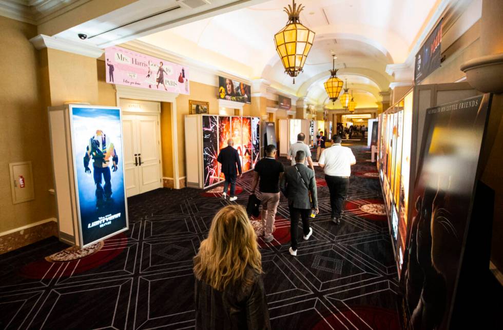 Attendees walk by movie displays at the CinemaCon trade show at Caesars Palace on Tuesday, Apri ...