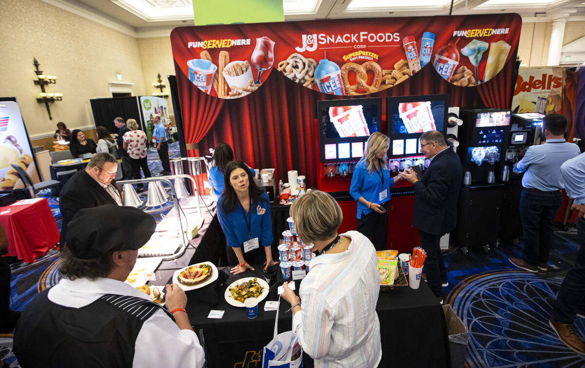 Kelly Shepard, national sales manager at J&J Snack Foods, talks with attendees at the Cinem ...