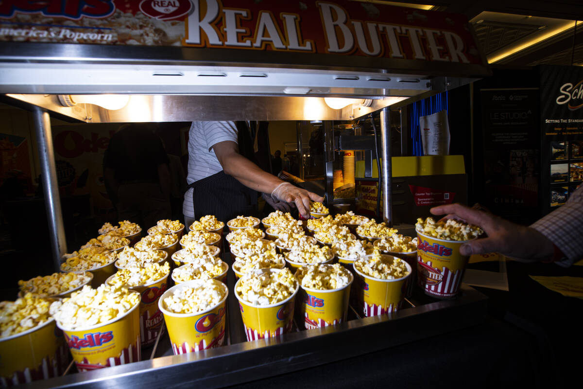 Popcorn is prepared at the booth for Odell's, a popcorn topping supplier, at the CinemaCon trad ...