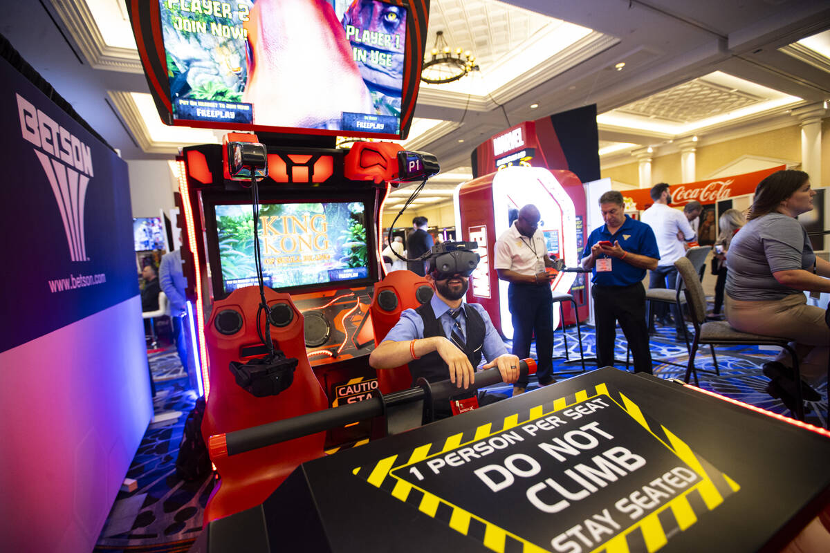 AJ Ferreri of The District Cinema tries out a virtual arcade game at the Betson Enterprises bo ...