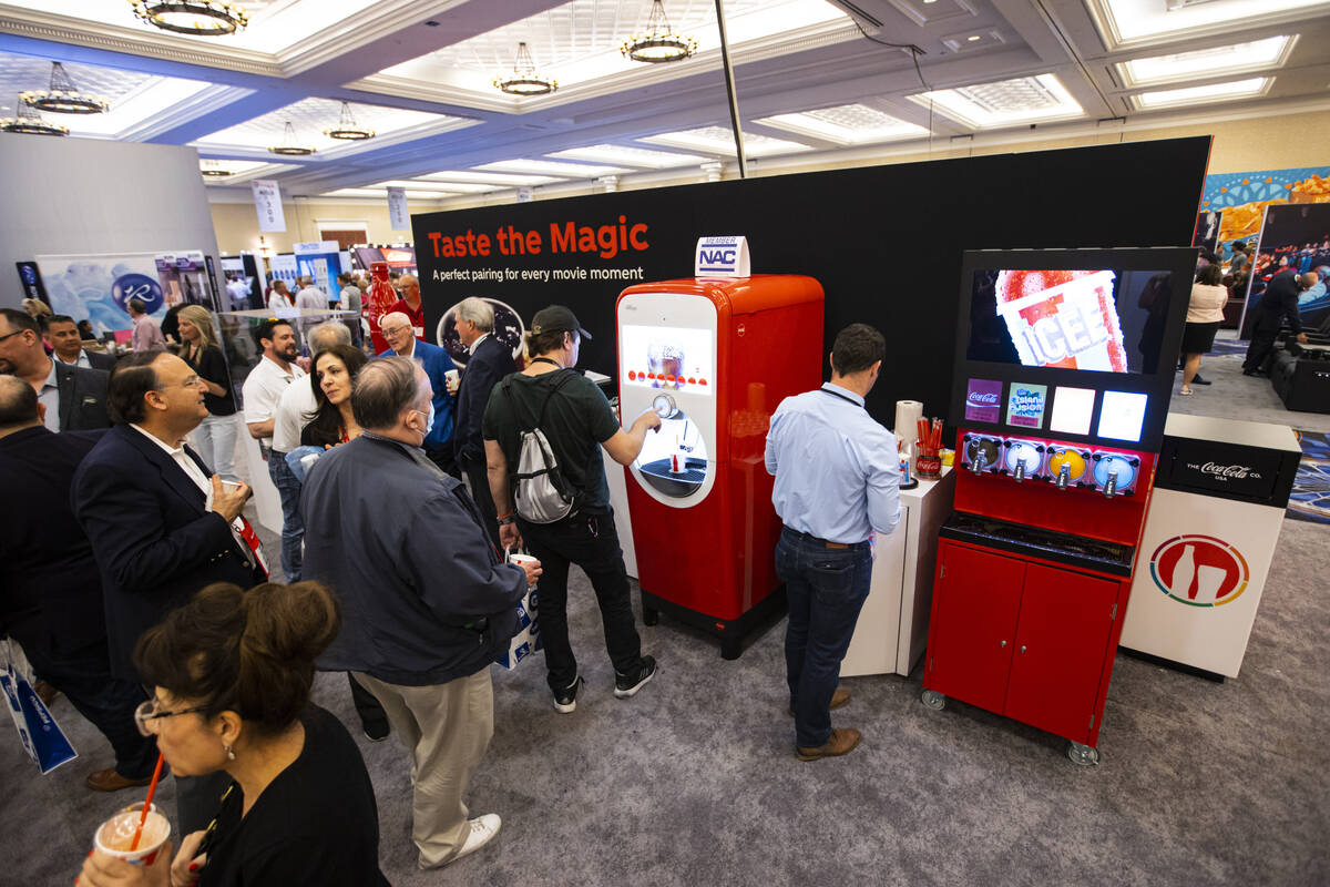 Attnedees line up to try products from Coca-Cola at the CinemaCon trade show at Caesars Palace ...