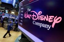 FILE - In this Aug. 8, 2017, file photo, The Walt Disney Co. logo appears on a screen above the ...