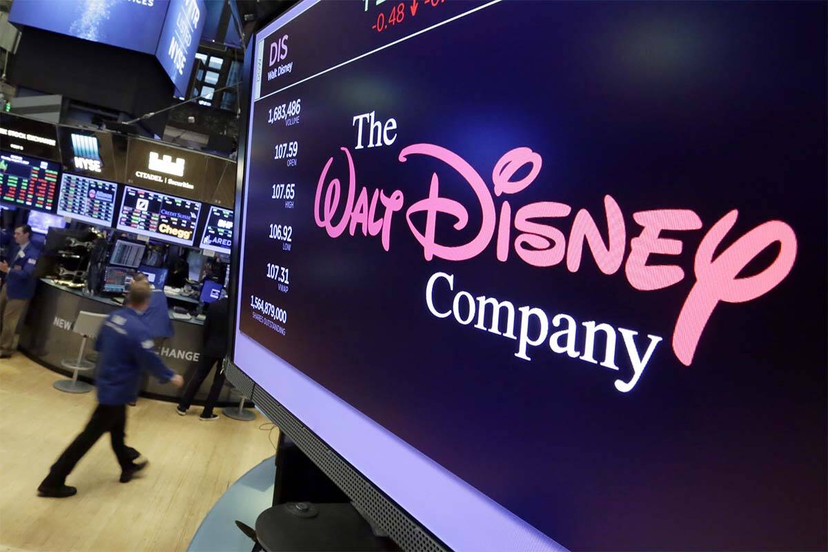 FILE - In this Aug. 8, 2017, file photo, The Walt Disney Co. logo appears on a screen above the ...