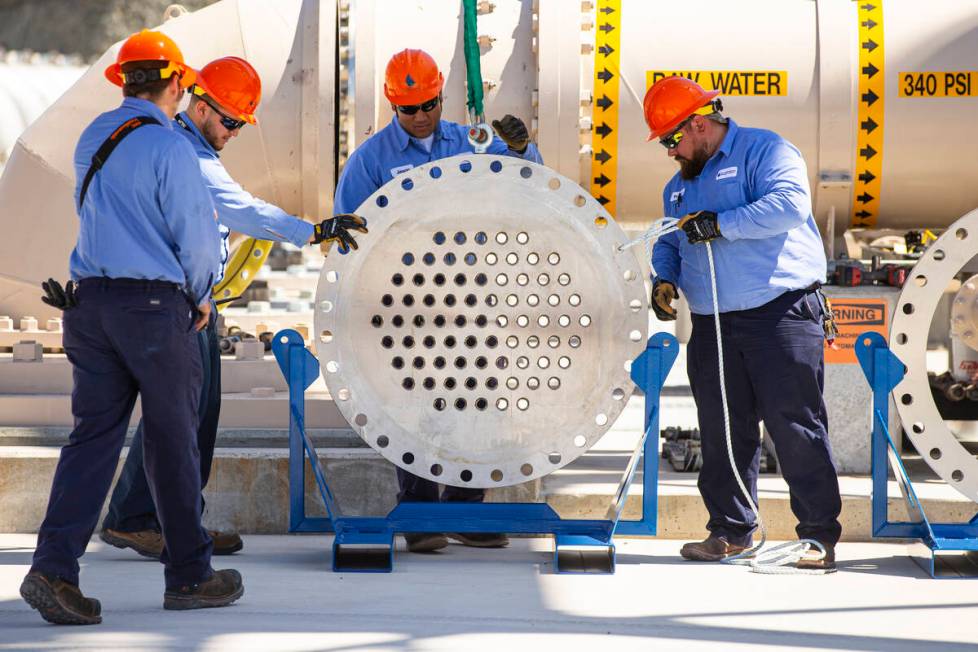 Southern Nevada Water Authority maintenance mechanics remove an energy dissipator before instal ...