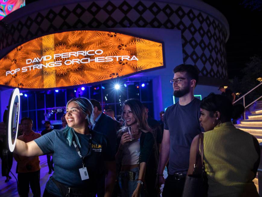 Ruthie Clarissa Torres, left, takes guests photos during an opening night party at Kaos at the ...