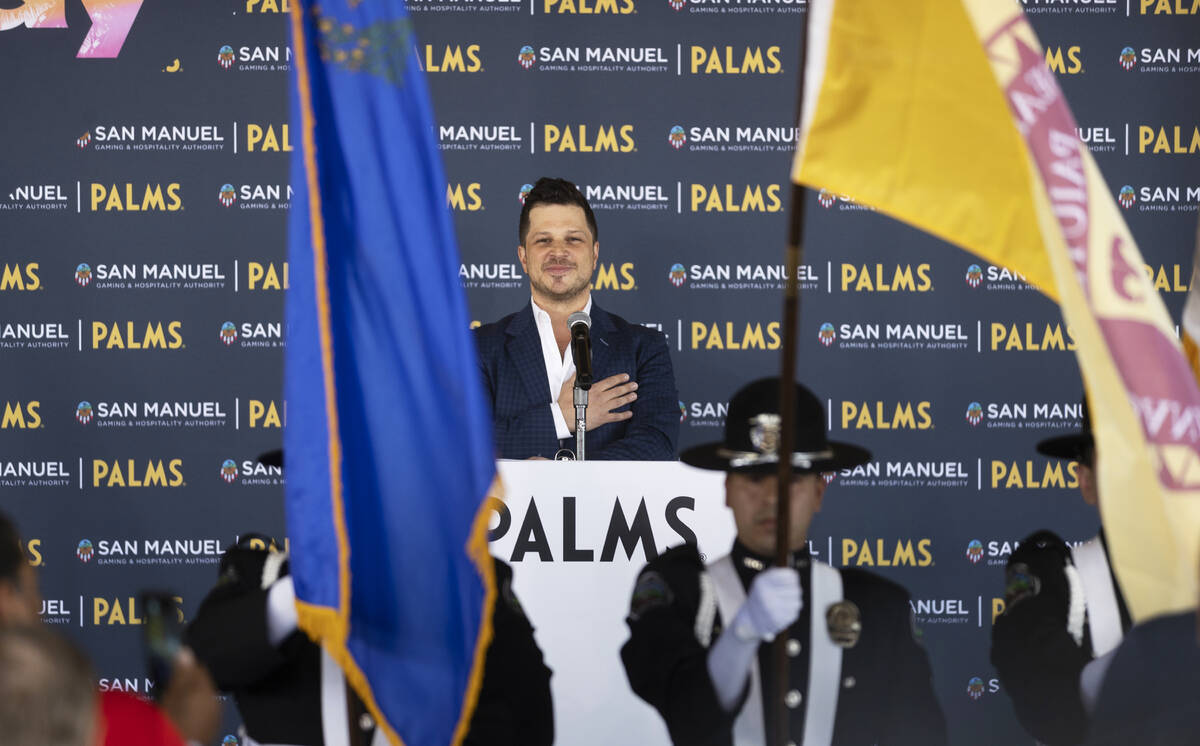 Emcee Mark Shunock listens to the national anthem during the reopening ceremony of the Palms on ...