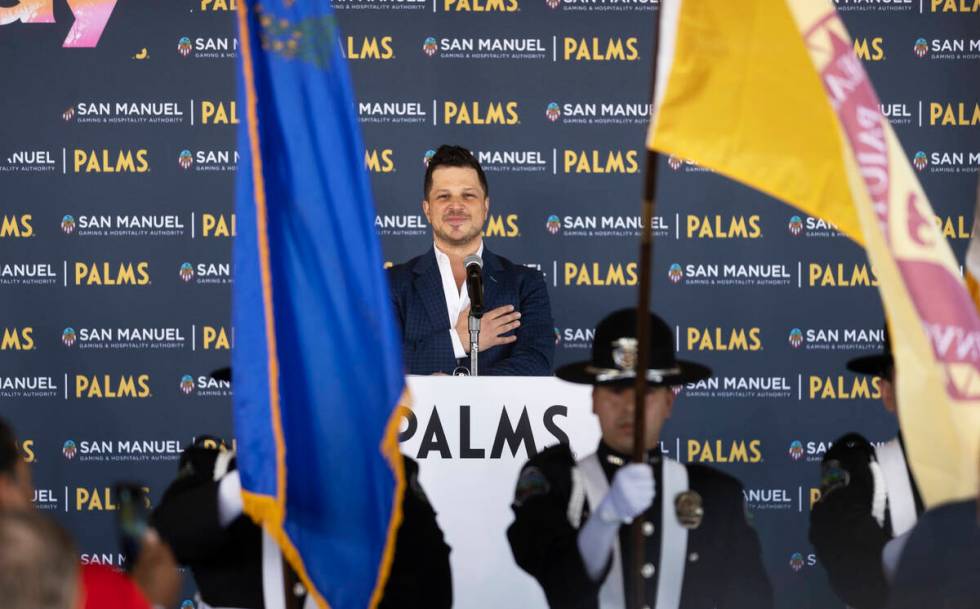 Emcee Mark Shunock listens to the national anthem during the reopening ceremony of the Palms on ...