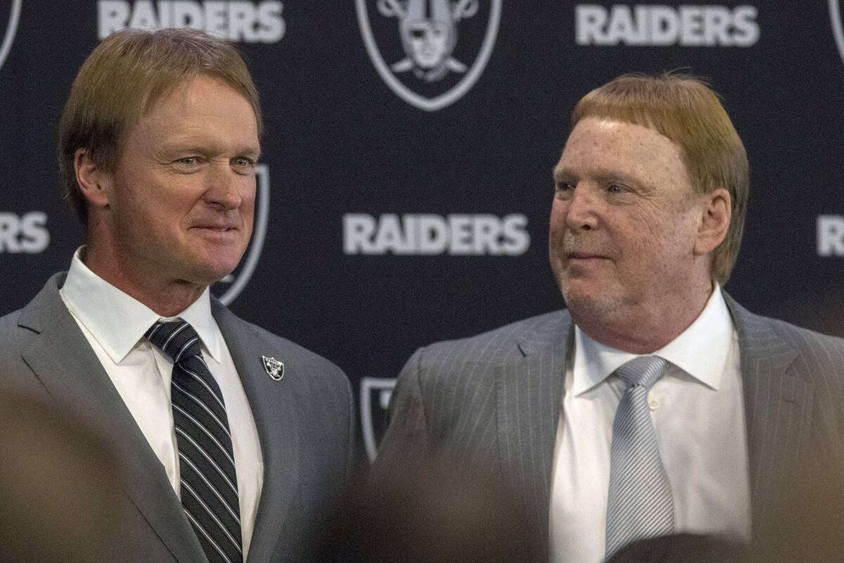 Jon Gruden, left, after being announced as the head coach of the Oakland Raiders with owner Mar ...