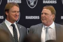 Jon Gruden, left, after being announced as the head coach of the Oakland Raiders with owner Mar ...