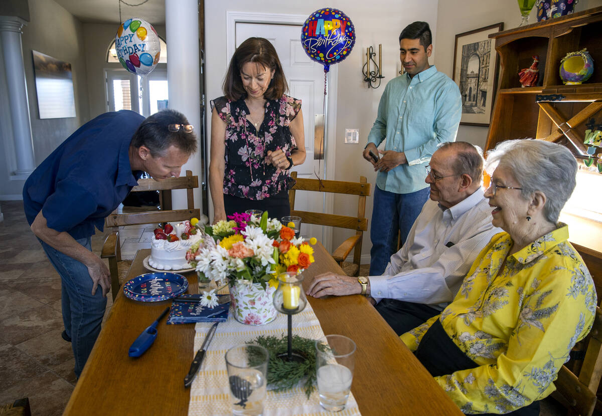 Scott Hoffman,left, blows out birthday candles as his wife Ellen, Benny and her parents Mark an ...