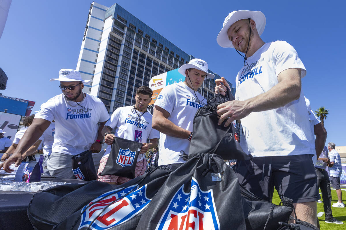 A 2022 NFL draft prospect Aidan Hutchinson of Michigan, right, is joined by George Karlaftis of ...