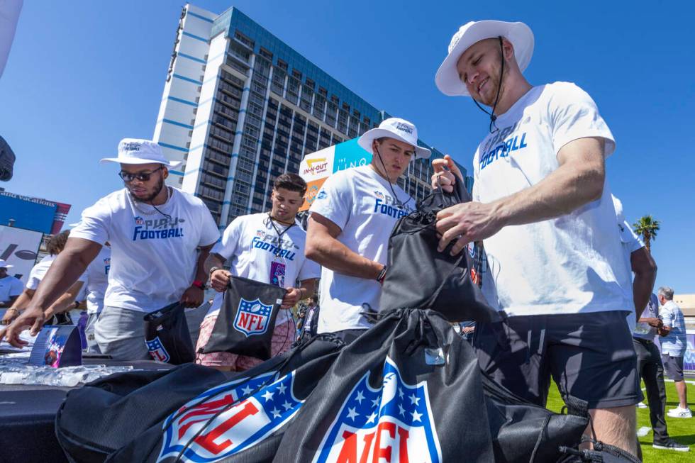 A 2022 NFL draft prospect Aidan Hutchinson of Michigan, right, is joined by George Karlaftis of ...