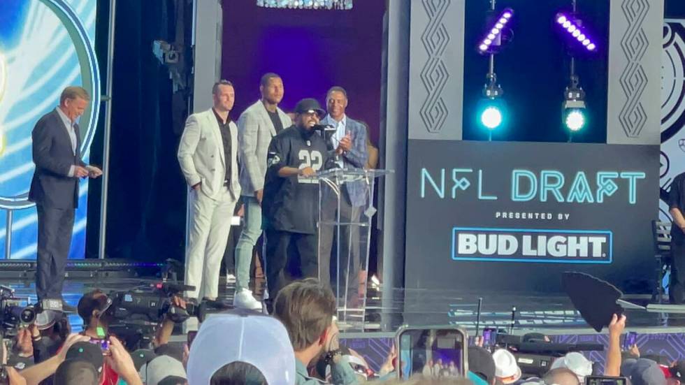 Ice Cube revs up the crowd at the start of the NFL draft as Commissioner Roger Goodell, left, c ...