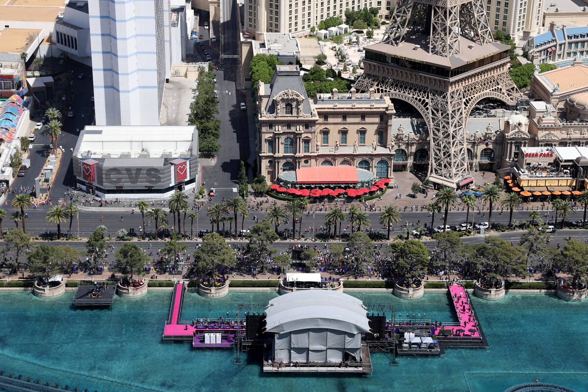 Fans watch the red carpet from the closed Strip on the fountains of the Bellagio in Las Vegas T ...