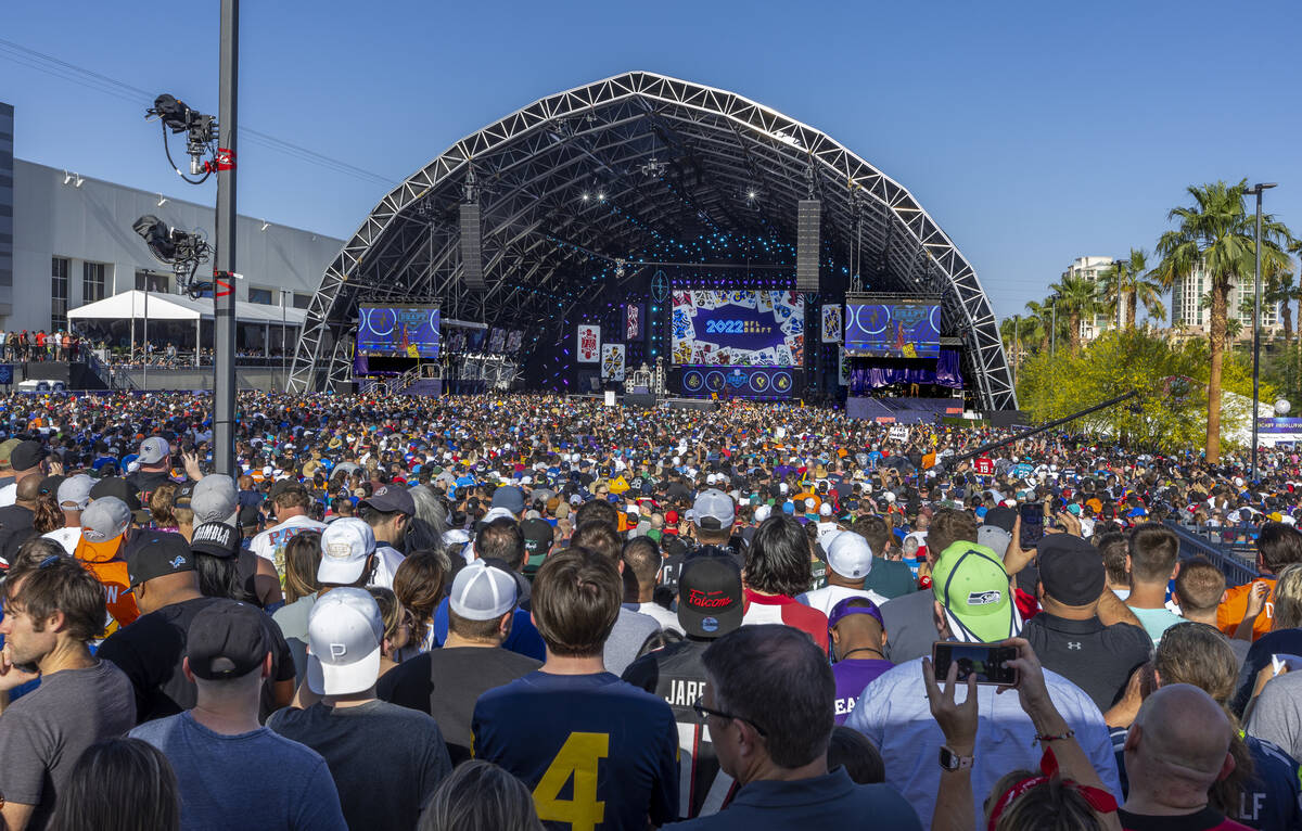 A crowd gathers to watch the start of the 2020 NFL Draft from the Draft Theater within the Draf ...