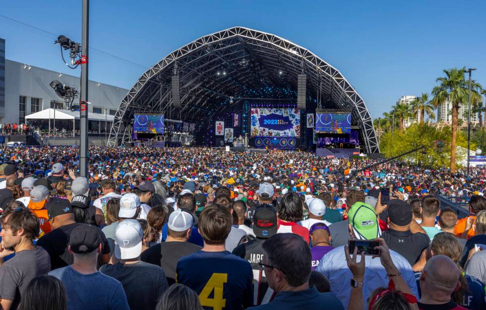 A crowd gathers to watch the start of the 2020 NFL Draft from the Draft Theater within the Draf ...