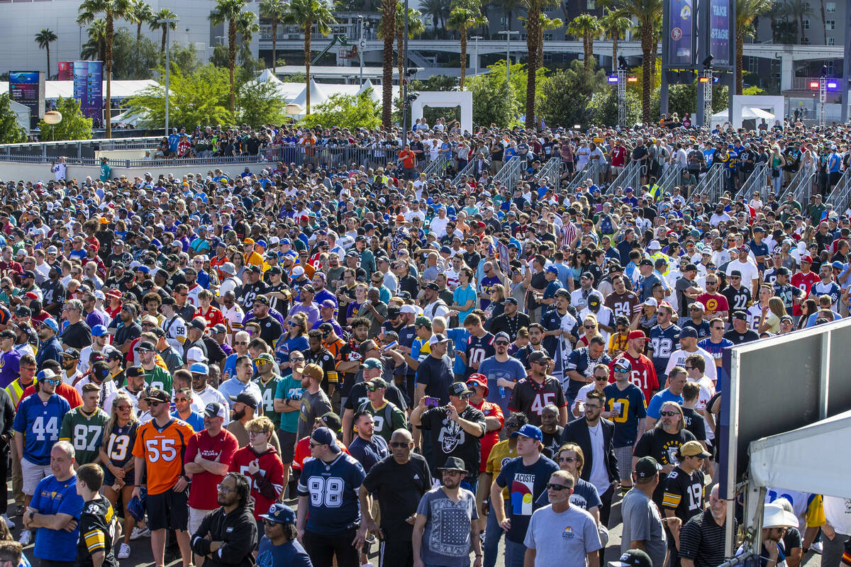 A crowd gathers to watch the start of the 2020 NFL Draft from the Draft Theater within the Draf ...