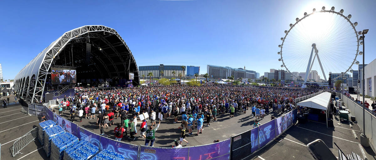 A crowd gathers to watch the start of the 2020 NFL Draft from the Draft Theater within the Draf ...