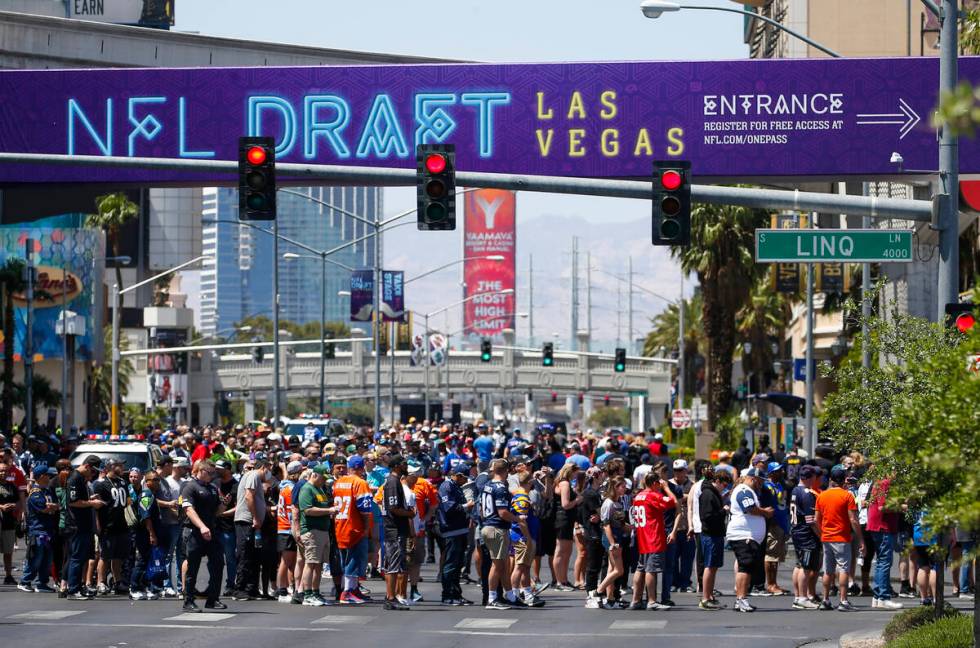 Football fans arrive for the first day of the NFL draft on Thursday, April 28, 2022, in Las Veg ...