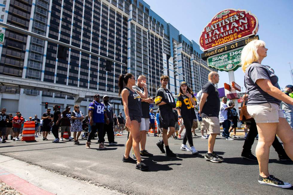 Football fans arrive for the first day of the NFL draft on Thursday, April 28, 2022, in Las Veg ...