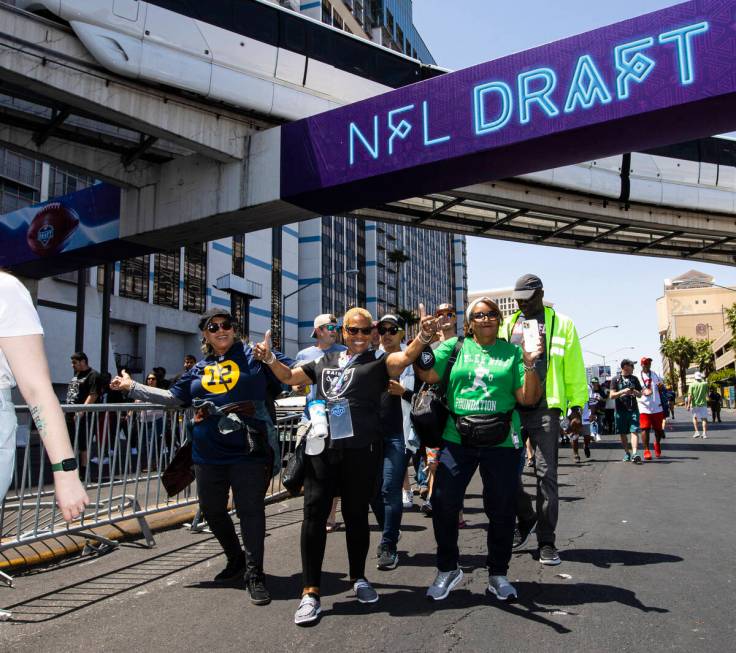 Football fans arrive for the first day of the NFL draft on Thursday, April 28, 2022, in Las Veg ...