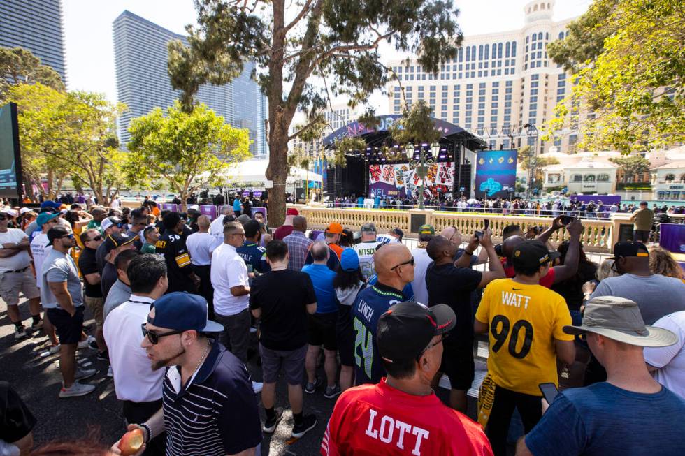 Crowds take in the sight of the red carpet stage at the Bellagio Fountains during the first day ...