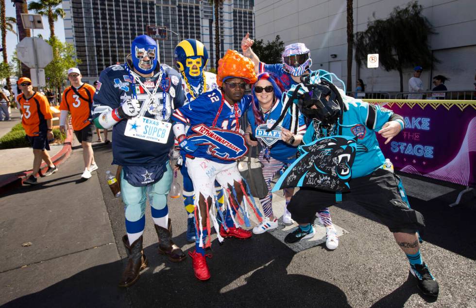 Members of Elite Super Fans poses for a picture during the first day of the NFL draft on Thursd ...