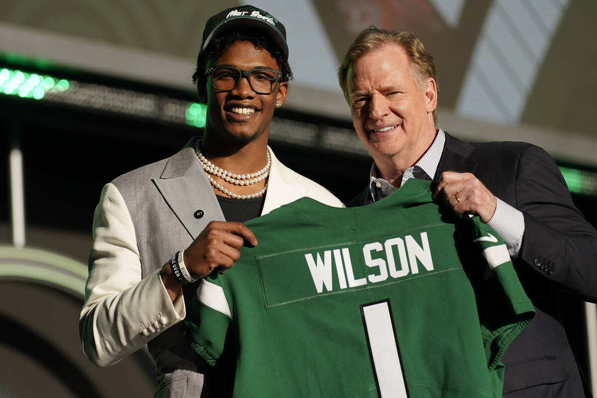 Ohio State wide receiver Garrett Wilson stands with NFL Commissioner Roger Goodell after being ...