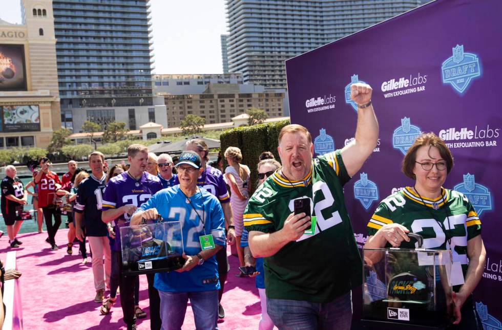 Super fans walk onto the NFL Red Carpet Stage on Thursday, April 28, 2022, at the Bellagio Foun ...